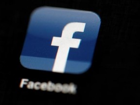 FILE - In this May 16, 2012, file photo, the Facebook logo is displayed on an iPad in Philadelphia. Facebook told The Associated Press on Aug. 16, 2017, it has banned the Facebook and Instagram accounts of one of a white nationalist who attended a rally in Charlottesville, Virginia, that ended in deadly violence. (AP Photo/Matt Rourke, File)