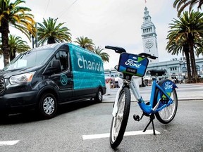 FILE - This Thursday, Sept. 8, 2016, file photo taken in San Francisco and provided by Ford Motor Company shows a Ford Transit passenger van operated by Chariot shuttle service and a bicycle operated by bike-share company Motivate. New Ford CEO Jim Hackett says the company isn‚Äôt taking its eyes off the present as it prepares for transportation in the future. In September 2016, Ford bought Chariot, an app-based shuttle service that originally operated 100 14-passenger vans in the San Francisco