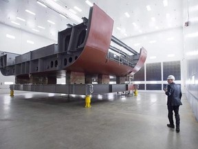 Kevin McCoy, president of Irving Shipbuilding, leads a tour as workers construct components of the Arctic offshore patrol ships at their facility in Halifax on Friday, March 4, 2016. The Canadian subsidiary of French defence giant Thales has been awarded a multibillion-dollar contract to service Canada&#039;s new fleet of Arctic offshore patrol ships and joint support vessels.THE CANADIAN PRESS/Andrew Vaughan