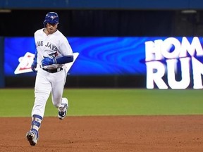 Toronto Blue Jays first baseman Justin Smoak (14) rounds the bases after hitting a two-run home run against the Tampa Bay Rays during eighth inning AL baseball action in Toronto on Thursday, August 17, 2017. THE CANADIAN PRESS/Nathan Denette
