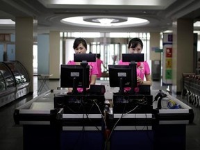 In this Monday, June 19, 2017, photo, cashiers stand at checkout counters waiting to serve customers at the Potonggang department store in Pyongyang, North Korea. Three generations into Kim Jong Un&#039;s ruling dynasty, markets have blossomed and a consumer culture is taking root. (AP Photo/Wong Maye-E)
