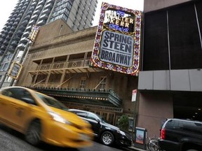 A taxi cab passes the Walter Kerr Theater, home to the Broadway show &ampquot;Springsteen on Broadway,&ampquot; in New York&#039;s Theater District, Friday, Aug. 18, 2017. The upcoming show will be the one of the latest to offer up tickets for sale using new technology, called Verified Fan, to try to keep re-sellers and brokers from snapping them all up. (AP Photo/Richard Drew)