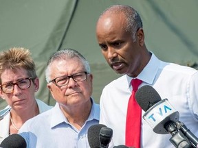 Ahmed Hussen, right, Minister of Immigration, Refugees and Citizenship, Ralph Goodale, Minister of Public Safety and Emergency Preparedness, and Brenda Shanahan, MP for Chateauguay-Lacolle, comment on the influx of asylum seekers crossing the border into Canada from the United States Monday, August 21, 2017 near Saint-Bernard-de-Lacolle, Que. THE CANADIAN PRESS/Paul Chiasson