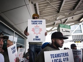 Striking workers are seen picketing at Pearson International Airport in Toronto on Friday, July, 28, 2017. About 700 ground crew workers at Canada&#039;s busiest airport are voting today on whether to accept a new contract offer and potentially end a four-week-long work stoppage.THE CANADIAN PRESS/Christopher Katsarov