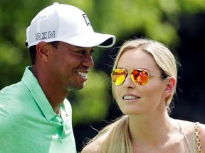 FILE - In this April 8, 2015, file photo, Lindsey Vonn speaks to Tiger Woods during the Par 3 contest at the Masters golf tournament in Augusta, Ga. In a statement on Aug. 22, 2017, Vonn called the theft and publishing of ‚Äúintimate‚Äù personal photos of her and former boyfriend Woods ‚Äúan outrageous and despicable invasion of privacy.‚Äù (AP Photo/Charlie Riedel, File)