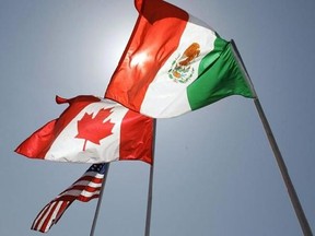 In this April 21, 2008 file photo, national flags of the United States, Canada, and Mexico fly in New Orleans. Canada, the United States, and Mexico have entered a confidentiality agreement to protect each other&#039;s offers during NAFTA negotiations, with a list of rules designed to prevent leaks during the talks. THE CANADIAN PRESS/AP/Judi Bottoni