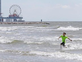Caleb Armstrong, 9, of Venus, Texas plays on the beach Thursday, Aug. 24, 2017, in Galveston, Texas. The family had just arrived in Galveston today for a long weekend vacation despite the possibility of rains and flooding from Hurricane Harvey. Harvey intensified into a hurricane Thursday and steered for the Texas coast with the potential for up to 3 feet of rain, 125 mph winds and 12-foot storm surges in what could be the fiercest hurricane to hit the United States in almost a dozen years. (Mel