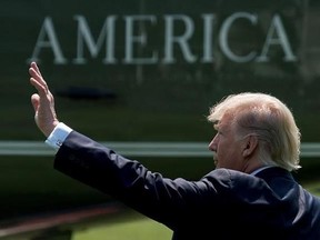 FILE - In this Tuesday, Aug. 22, 2017, file photo, President Donald Trump waves as he walks across the South Lawn of the White House in Washington to board Marine One for a short trip to Andrews Air Force Base, Md. and then onto Yuma, Ariz., to visit the U.S. border with Mexico and attend a rally in Phoenix. (AP Photo/Andrew Harnik, File)