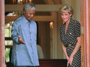 FILE - In this Monday, March 17, 1997 file photo, South African President Nelson Mandela, left, shows the way to Princess Diana, during a meeting in Cape Town. It has been 20 years since the death of Princess Diana in a car crash in Paris and the outpouring of grief that followed the death of the ‚Äúpeople‚Äôs princess.‚Äù (AP Photo/Sasa Kralj, File)
