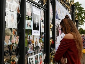 A woman looks at tributes and memorabilia for the late Diana, Princess of Wales outside Kensington Palace in London, Tuesday, Aug. 29, 2017. The tributes are placed on one of the ornamental gates at the palace ahead of the 20th anniversary of Princess Diana&#039;s death, in a car crash in Paris Aug. 31, 1997. (AP Photo/Alastair Grant)