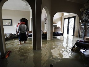 Mike Stamps stands in his home in the Kingwood Greens Subdivision flooded from the San Jacinto River due to Tropical Storm Harvey, Wednesday, Aug. 30, 2017, in Kingwood, Texas. Stamps was there to retrieve his two cats , who had to be left behind, as he was evacuated on a jet ski Tuesday.