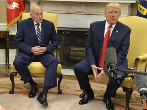 President Donald Trump (R) speaks to the press after White House Chief of Staff John Kelly (L) was sworn in, in the Oval Office of the White House, July 31, 2017 in Washington,