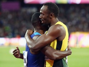Usain Bolt of Jamaica, right, hugs Justin Gatlin of the United States following Gatlin's win in the men's 100 metres final in 9.92 seconds on Saturday.  Alexander Hassenstein/Getty Images