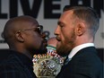 Boxer Floyd Mayweather Jr., left, and UFC lightweight champion Conor McGregor stare each other down during a news conference at the KA Theatre at the MGM Grand Hotel & Casino on Wednesday, Aug. 23, 2017 in Las Vegas.