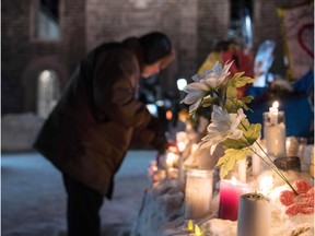 Alexandre Bissonnette was charged Jan. 30 with six counts of murder over a shooting spree at a Quebec mosque -- one of the worst attacks ever to target Muslims in a western country. Above, mourners place flowers at the site of the shooting.