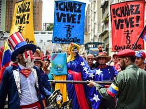 Pro-government activists representing a Venezuelan Bolivarian revolutionary (R) and America's Uncle Sam (L) perform during a demonstration to support President Nicolas Maduro, in Caracas on Aug. 14.