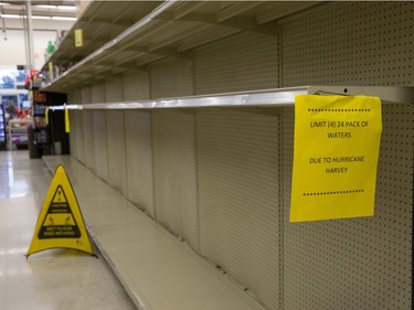 An Austin-Area grocer shelves are empty as they keep bottled water and other essential items stocked and sell limited quantities on August 27, 2017, during the aftermath of Hurricane Harvey which hit the Texas Golf coast.