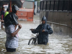INDIA-WEATHER-FLOOD

Indians wade through a flooded street during heavy rain showers in Mumbai on August 29, 2017. Heavy rain brought India's financial capital Mumbai to a virtual standstill on August 29, flooding streets, causing transport chaos and prompting warnings to stay indoors. Dozens of flights and local train services were cancelled as rains lashed the coastal city of nearly 20 million people.  / AFP PHOTO / PUNIT PARANJPEPUNIT PARANJPE/AFP/Getty Images
PUNIT PARANJPE, AFP/Getty Images