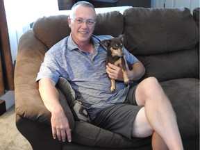 Todd Bertrend at home with his dog Coco.