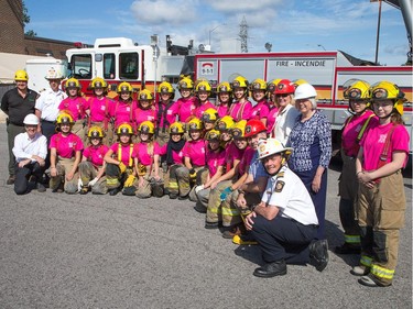 Twenty four young women in pink t-shirts joined politicians and Ottawa Fire Service Chiefs for a group photo as the week long Camp FFIT continues at the Ottawa Fire Services Training Centre.
