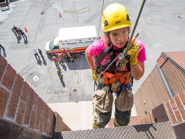 Savanna Cleveland rappels down the tower as the week long Camp FFIT continues at the Ottawa Fire Services Training Centre on Industrial Ave where teenage girls are educated about the career of firefighting. Participants took part in Search and Rescue, Auto extrication, Forcible entry, Catching hydrants, High rise operations, rappelling, and aerial ladder climb among other things.