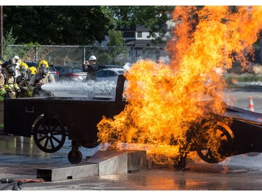 A simulated car fire is extinguished as the week long Camp FFIT continues at the Ottawa Fire Services Training Centre on Industrial Ave where teenage girls are educated about the career of firefighting. Participants took part in Search and Rescue, Auto extrication, Forcible entry, Catching hydrants, High rise operations, rappelling, and aerial ladder climb among other things.