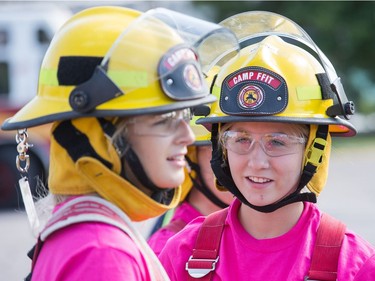 Olivia Winch (L) and Dayna Bekkers (C) have a chat as the week long Camp FFIT continues at the Ottawa Fire Services Training Centre.