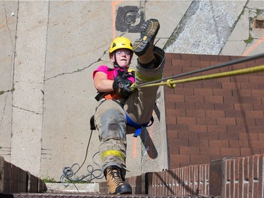 Emma Barton inverts herself while rappelling as the week long Camp FFIT continues at the Ottawa Fire Services Training Centre.