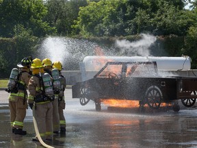 File: A simulated car fire is extinguished as the week-long Camp FFIT continues at the Ottawa Fire Services Training Centre.