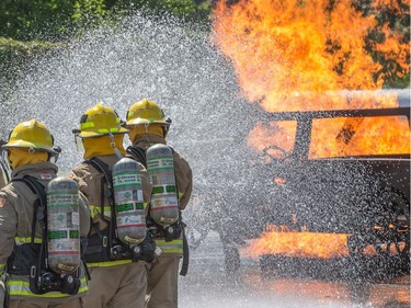 A simulated car fire is extinguished as the week long Camp FFIT continues at the Ottawa Fire Services Training Centre.