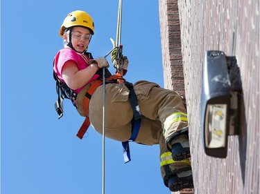 Kayla Brunetta begins rappelling down the tower as the week long Camp FFIT continues at the Ottawa Fire Services Training Centre.