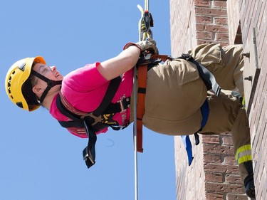 Kayla Brunetta begins rappelling down the tower as the week long Camp FFIT continues at the Ottawa Fire Services Training Centre.