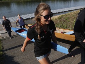 Lexy Vincent carries her boat from the Red River at the Manitoba Canoe and Kayak Centre, home of the Canada Games races. THE CANADIAN PRESS/John Woods