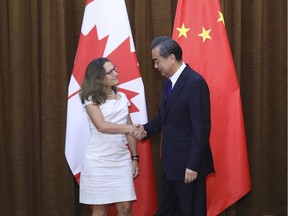 Foreign Minister Chrystia Freeland, left, is greeted by China's Foreign Minister Wang Yi as she arrives for a meeting at the Ministry of Foreign Affairs in Beijing on Aug. 9, 2017.