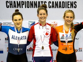 Ottawa cyclist Katherine Maine, middle, celebrates after her gold-medal performance in the junior women's two-day omnium race at the Canadian track cycling championships in Milton.