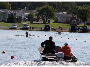 Race officials look on during the women's women's single sculls race at Kenora on Friday. SHERI LAMB/Postmedia