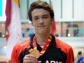 Henry McKay of Ottawa displays his gold medal after winning the men's one-metre springboard diving competition in the Canada Summer Games at Winnipeg on Tuesday. Team Ontario photo