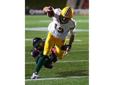 Redblacks linebacker Serderius Bryant (10) can't stop Eskimos quarterback Mike Reilly (13) from scoring a two-point convert in the fourth quarter. THE CANADIAN PRESS/Sean Kilpatrick