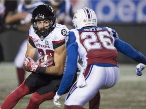 Redblacks wide receiver Brad Sinopoli keeps his eyes on Alouettes defensive back Tyree Hollins after making a catch in the first quarter of Thursday's contest. THE CANADIAN PRESS/Paul Chiasson