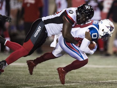 Alouettes kick returner Stefan Logan is tackled by the Redblacks' Ron Omara during second-quarter action at Molson Stadium on Thursday night. THE CANADIAN PRESS/Paul Chiasson