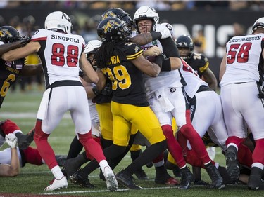 Redblacks third-string quarterback Ryan Lindley (14) gets caught up in traffic on a short-yardage play in the first half of Friday's contest. THE CANADIAN PRESS/Peter Power