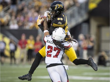 Tiger-Cats wide receiver Jalen Saunders (89) has the ball batted away by Redblacks defensive back Sherrod Baltimore on a pass attempt in the second half. THE CANADIAN PRESS/Peter Power