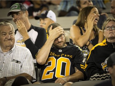 These Tiger-Cats fans are unimpressed by the home team's play during the second half of Friday's game at Tim Hortons Stadium. THE CANADIAN PRESS/Peter Power