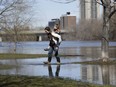 Alex Newman gets a piggy back from his mom Candace to cross a flooded section of Brighton Beach Park on March 8, 2017.