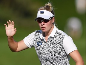 Nicole Broch Larsen of Denmark waves to the crowd at the 18th hole in the third round of the Canadian Pacific Women's Open in Ottawa on Saturday, Aug. 26, 2017.