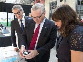 Ontario is helping people across the province save money and fight climate change through the Green Ontario Fund--a new not-for-profit provincial agency that will deliver programs and rebates to help reduce energy costs in homes and businesses. Minister of the Environment and Climate Change Chris Ballard (centre), made the announcement at Artscape Wychwood Barns on Wednesday, August 30, 2017, where he examines a smart thermostat with Green Ontario Fund Board chairman Parminder Sandhu (left) and Luliana Calin from Nest, a thermostat provider. The Green Ontario Fund will provide and install smart thermostats at no cost on a first-come-first-served basis.