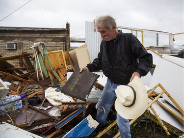 In this Aug. 26, 2017 photo, Harold Nubles searches through what is left of his barbecue truck in Refugio, Texas, that was destroyed by Hurricane Harvey.