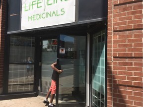 Staff check out the Lifeline Medicinals marijuana shop shortly after police raided it on Thursday, Aug. 24, 2017. The store restocked the shelves and reopened the next day.