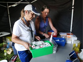Karen Whitehead, left, a volunteer peer support worker, and Amanda Woods, a developmental social worker with Ottawa Inner City Health, prepare the pop-up overdose prevention site in Ottawa on Friday, Aug. 25, 2017.