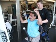 Trainer Ryan Armitage with John Woodhouse, who has dystonia and is a double leg amputee at the JCC in Ottawa, July 31, 2017.